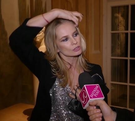 Magdalena Cielecka na scenie teatralnej, ukazana w intensywnym, emocjonalnym geście, z dramatycznym oświetleniem podkreślającym jej wyrazistą grę.