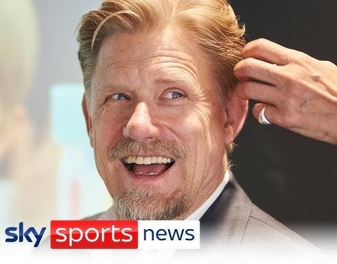 Peter Schmeichel w koszulce Manchesteru United, celebrujący zwycięstwo na boisku, z uniesionymi rękami i radosnym wyrazem twarzy.